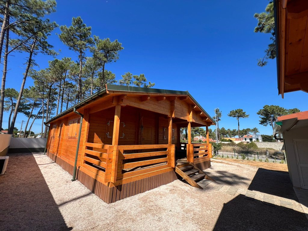 Casa de madeira maciça para alojamento local na Lagoa de Albufeira, Sesimbra, com alpendre coberto e pinhal ao fundo