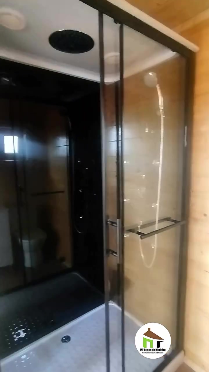 Cabine de duche em vidro na casa de banho da casa de madeira T0